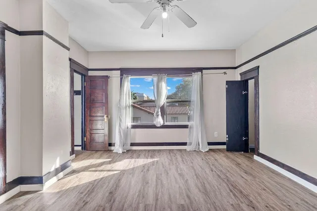 a bathroom with a granite countertop sink mirror vanity and toilet