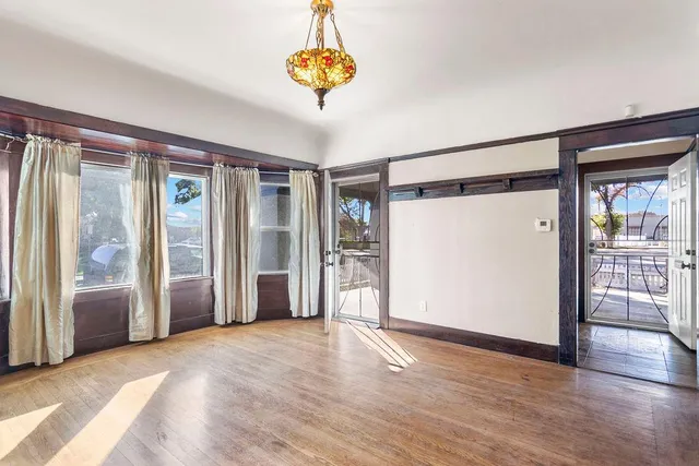 a view of an empty room with window and cabinet