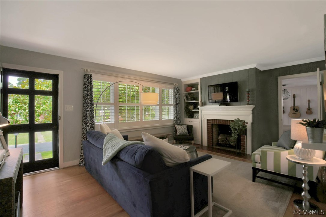 LIVING ROOM  divided light storm door and wood pla