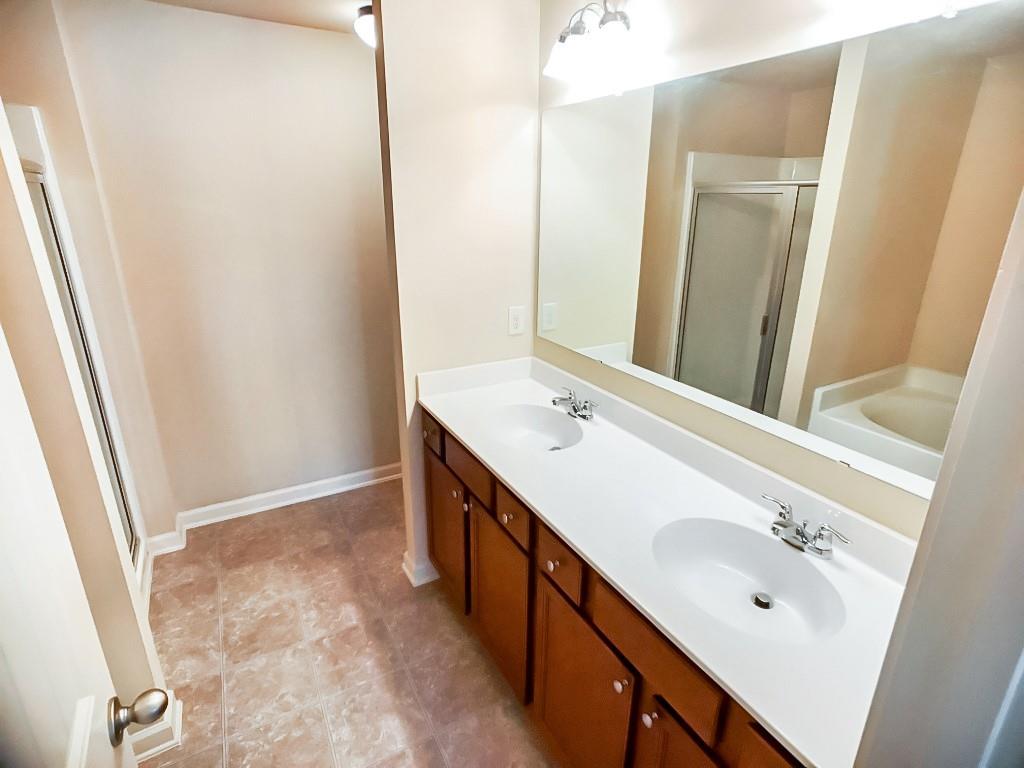 206 Madison Avenue Acworth, GA 30102 - Photo 26 of 39 a bathroom with a double vanity sink a and mirror
