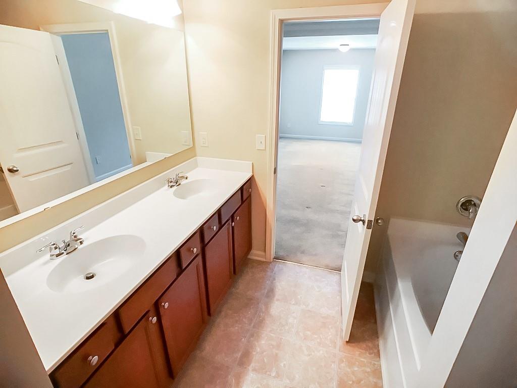 206 Madison Avenue Acworth, GA 30102 - Photo 28 of 39 a bathroom with a sink a mirror and a shower