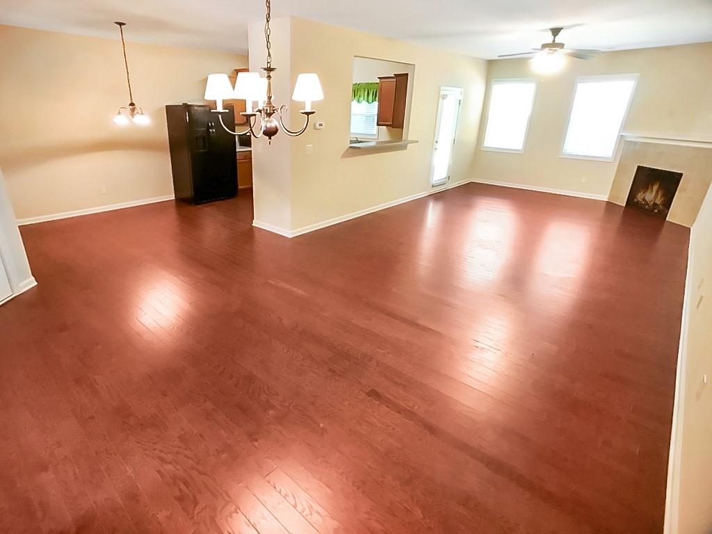 206 Madison Avenue Acworth, GA 30102 - Photo 6 of 39 a view of an empty room with wooden floor and a window