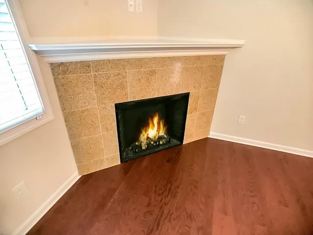 a view of a big room with wooden floor and windows