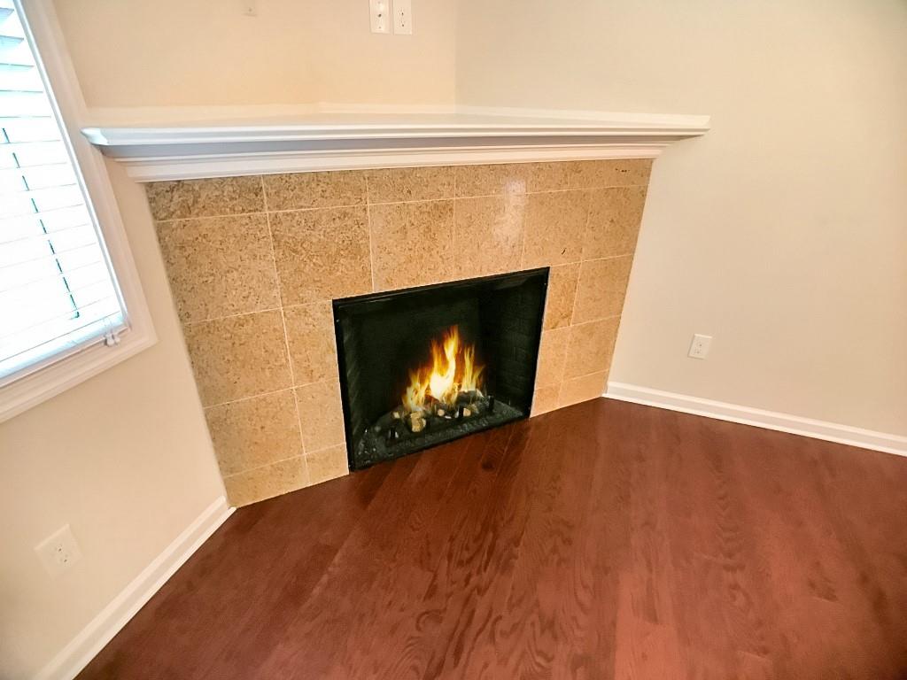 206 Madison Avenue Acworth, GA 30102 - Photo 7 of 39 a view of an empty room with a fireplace and a window