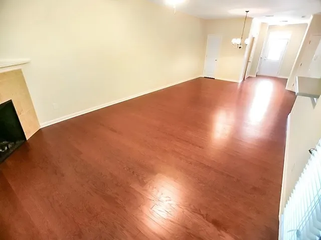 a view of a living room and kitchen with wooden floor