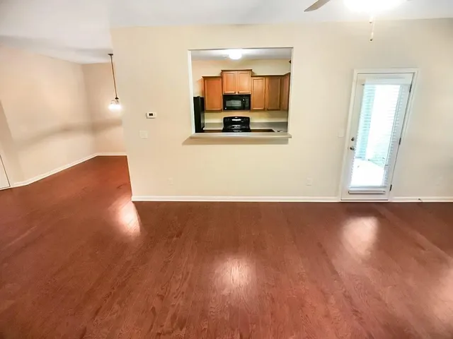 a kitchen with stainless steel appliances granite countertop a refrigerator a stove and a sink