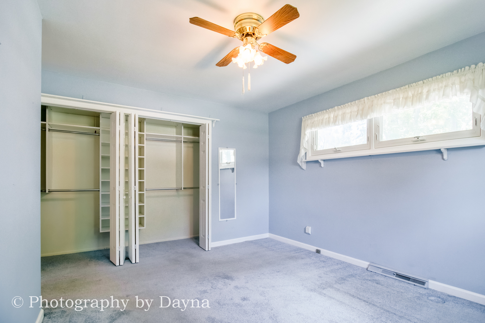 6 Park Place Kankakee, IL 60901 - Photo 17 of 36 an empty room with chandelier fan and windows