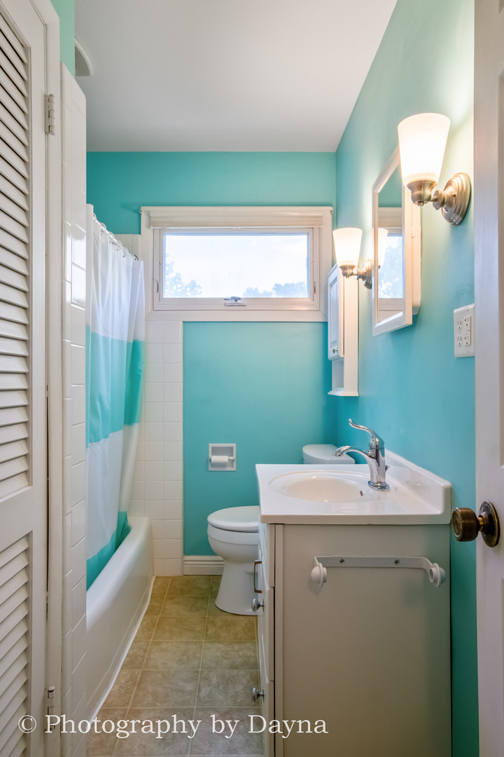 6 Park Place Kankakee, IL 60901 - Photo 23 of 36 a bathroom with a sink a mirror and a toilet