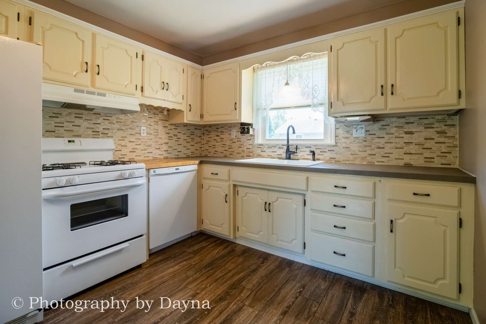 6 Park Place Kankakee, IL 60901 - Photo 6 of 36 a kitchen with cabinets stainless steel appliances and a window