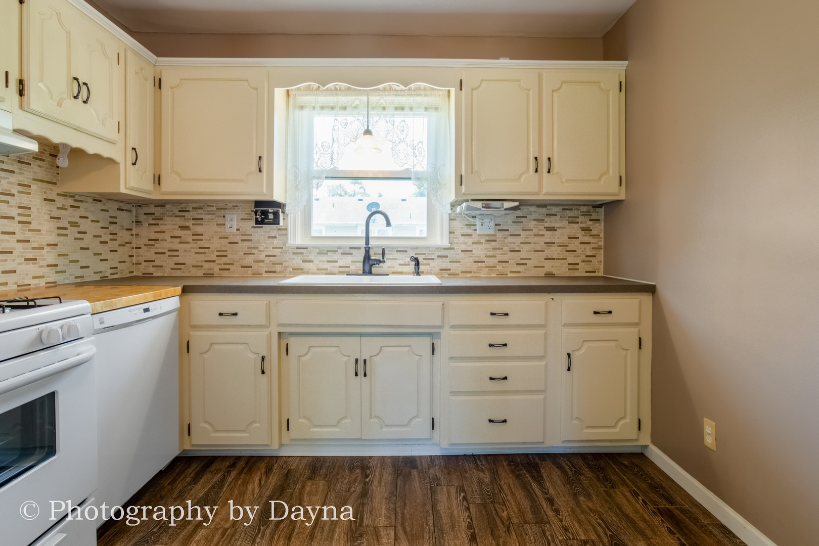 6 Park Place Kankakee, IL 60901 - Photo 7 of 36 a white kitchen with a sink and wooden floor