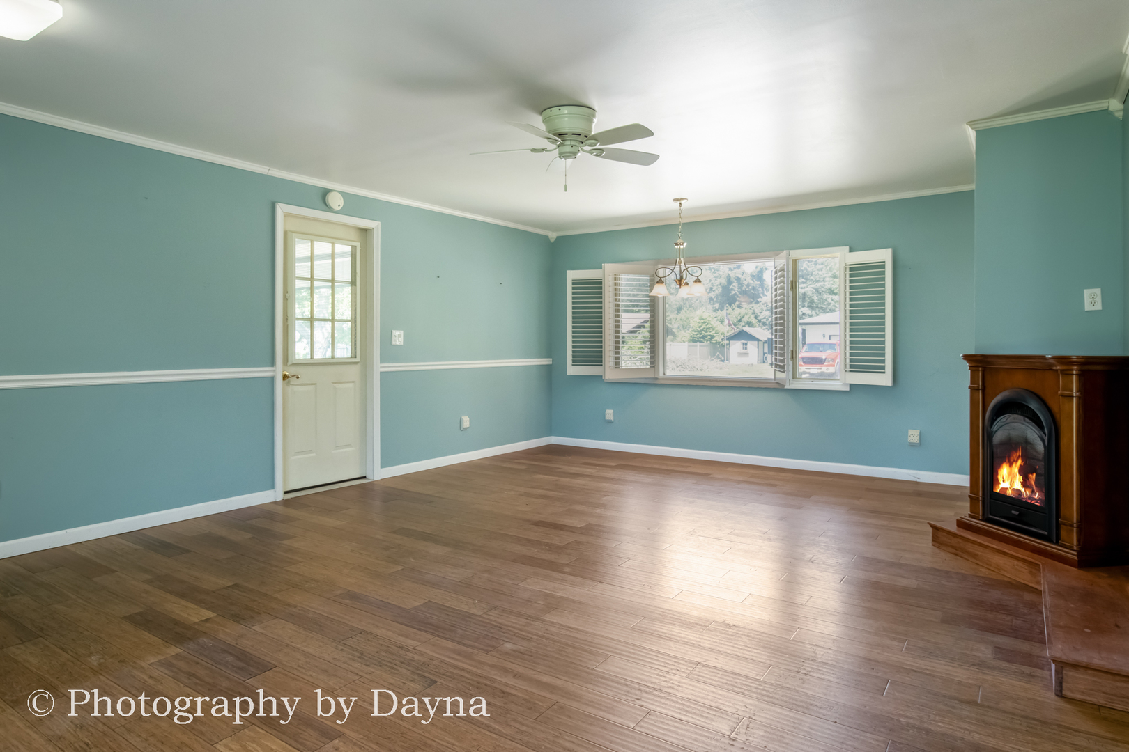 6 Park Place Kankakee, IL 60901 - Photo 8 of 36 an empty room with wooden floor fireplace and windows