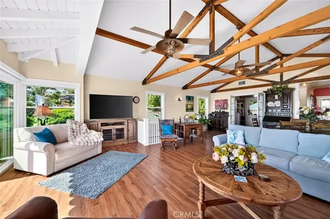a large kitchen with stainless steel appliances granite countertop a sink and cabinets with wooden floor