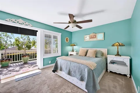 a bedroom with a large bed and a flat screen tv