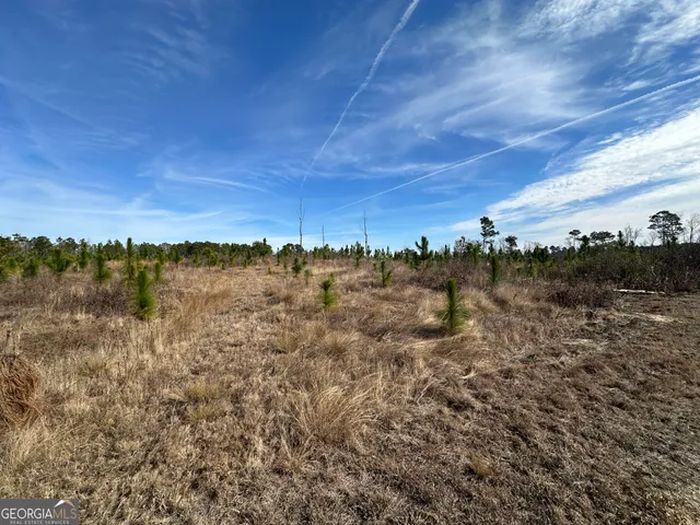 a view of mountain with sunset in background