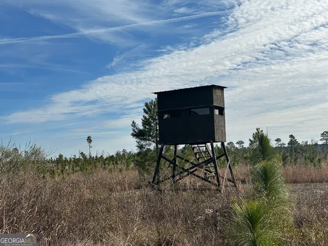 a view of a bench in front of a field