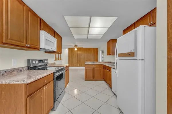 a kitchen with cabinets appliances and a counter top space