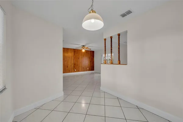 an empty room with wooden floor closet and windows
