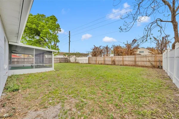 a view of a house with a backyard