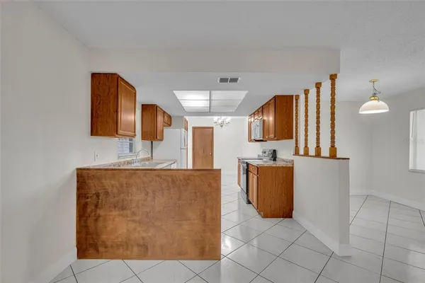 a kitchen with granite countertop cabinets and refrigerator