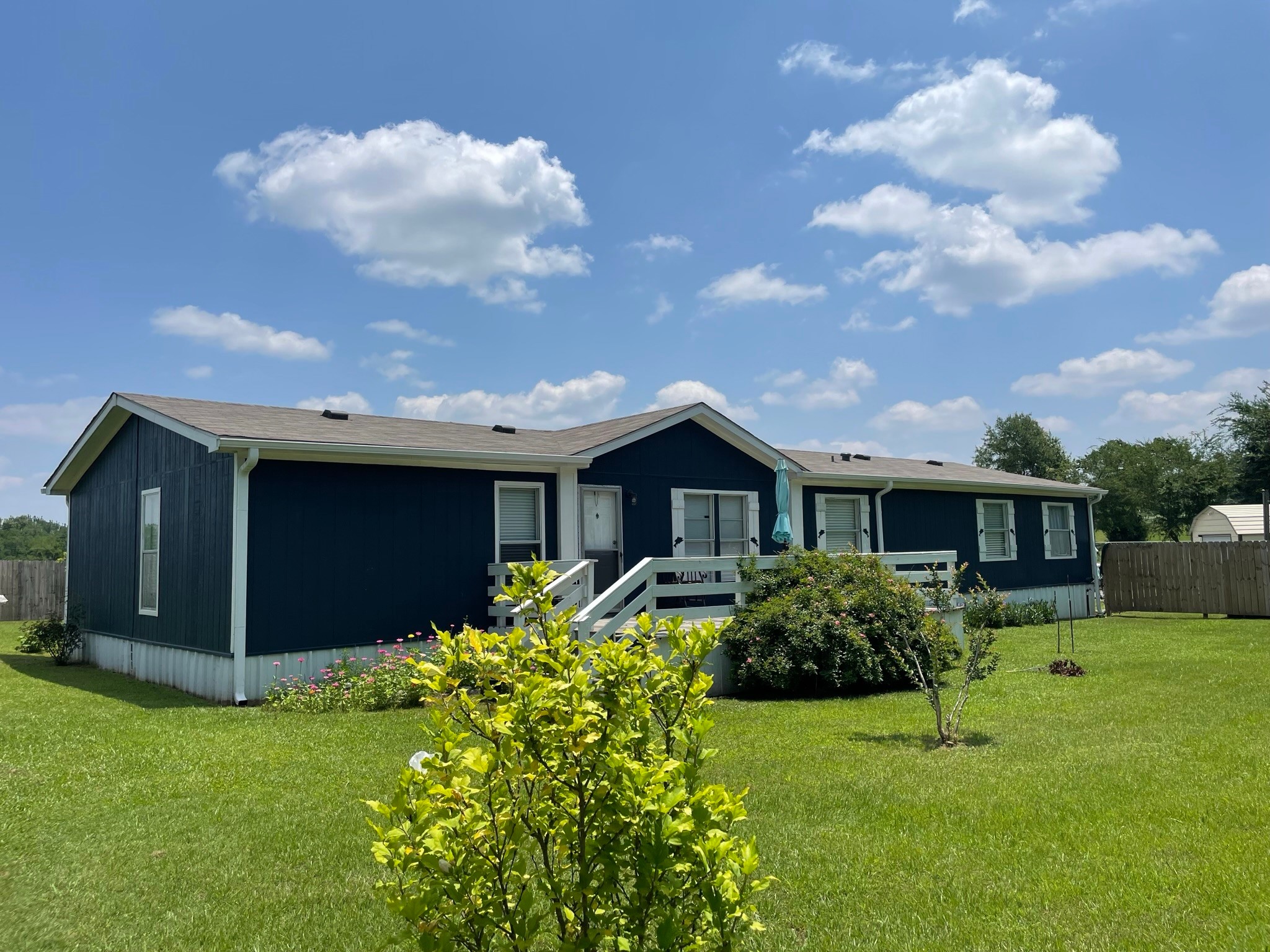 a view of house with yard