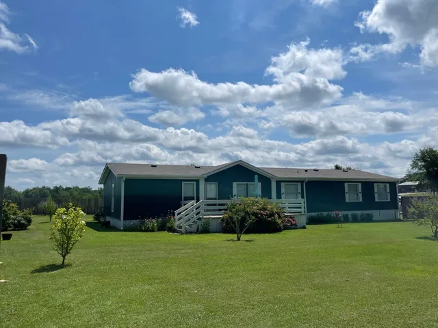 a front view of house with yard and green space
