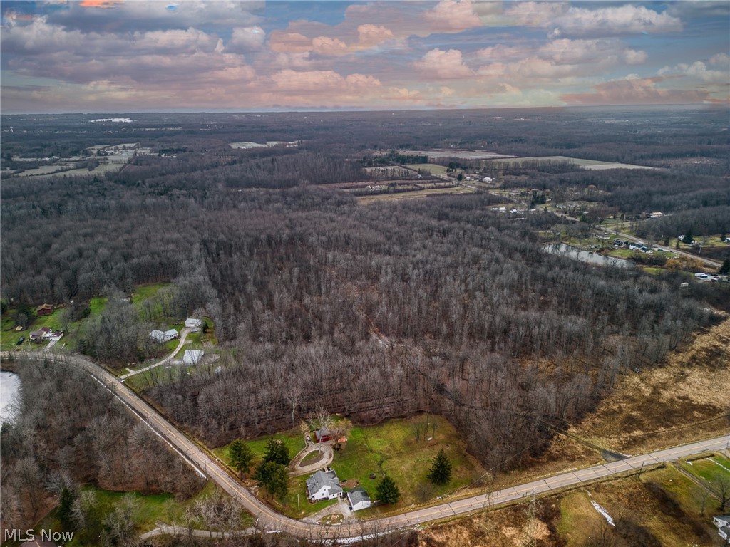 15594 Moseley Road Madison, OH 44057 - Photo 4 of 7 Aerial view of property and surrounding area featuring a heavily wooded area