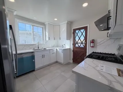 a kitchen with a stove a sink and a refrigerator