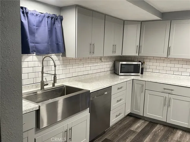 a kitchen with a sink cabinets and microwave