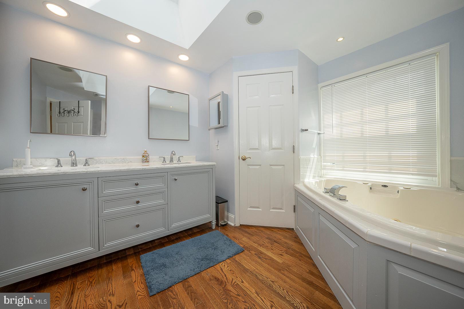 1416 Old Gulph Road Villanova, PA 19085 - Photo 15 of 41 a spacious bathroom with a double vanity sink a mirror and a bathtub
