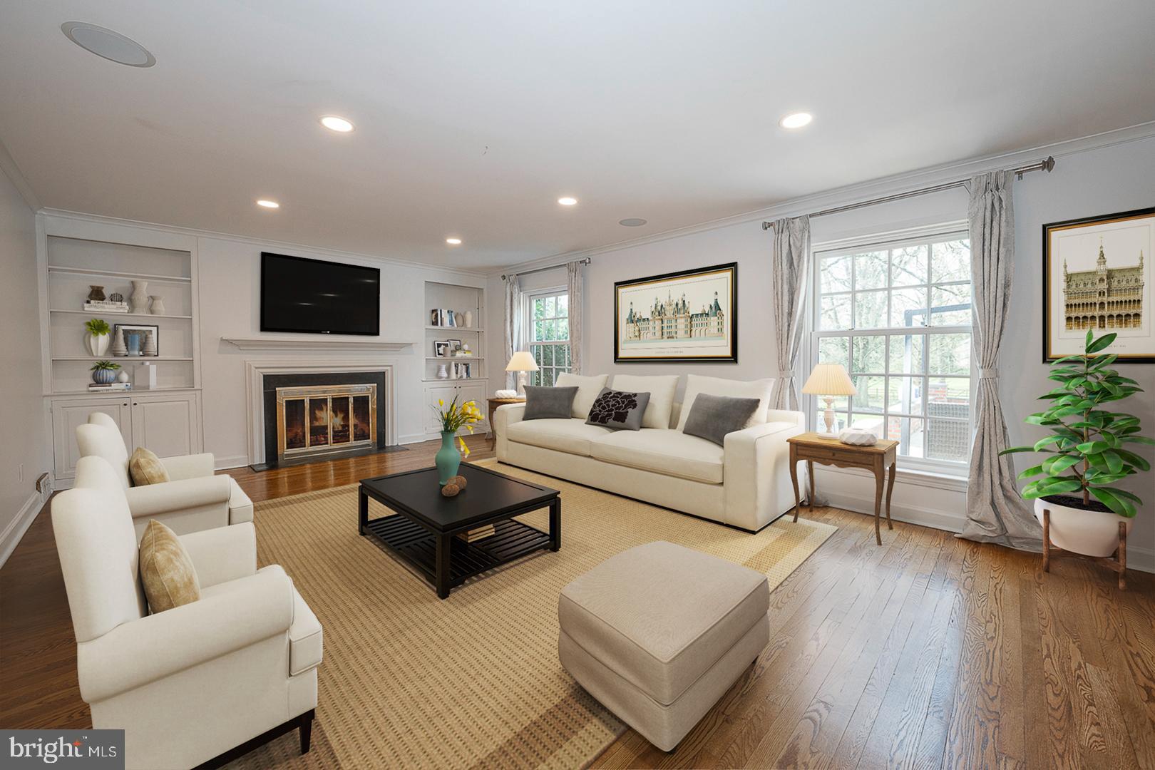 1416 Old Gulph Road Villanova, PA 19085 - Photo 2 of 41 a living room with furniture a flat screen tv and a fireplace