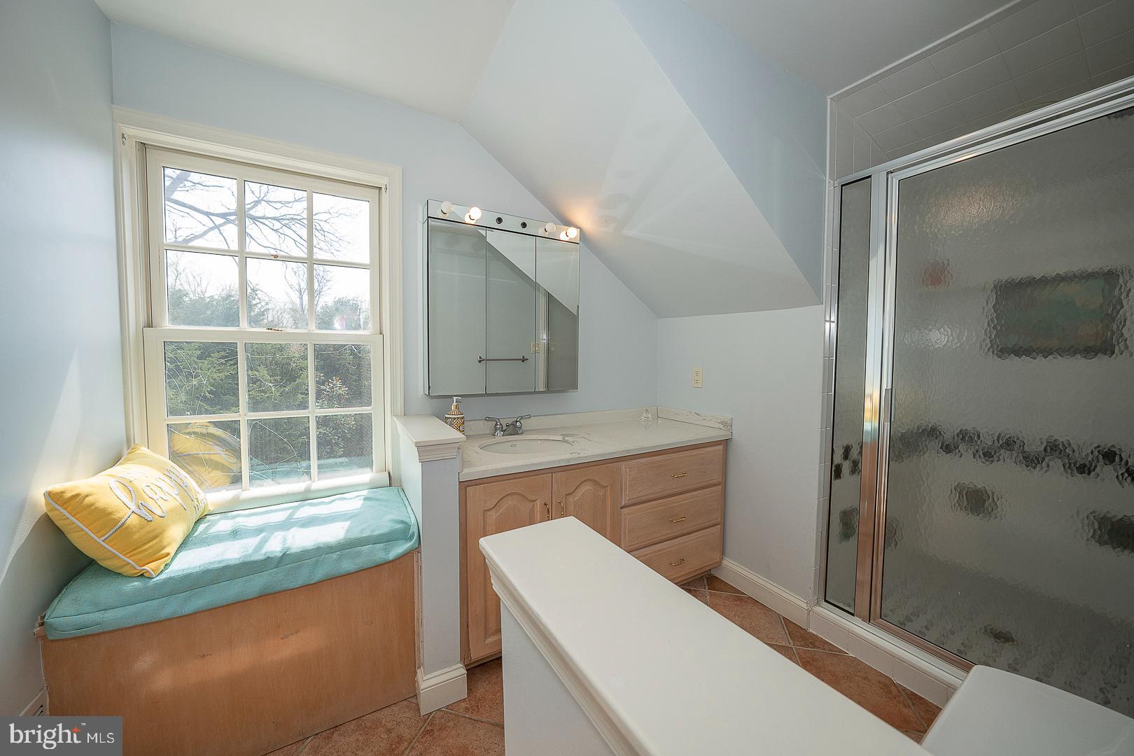 1416 Old Gulph Road Villanova, PA 19085 - Photo 25 of 41 a bathroom with a granite countertop sink a mirror and a bathtub