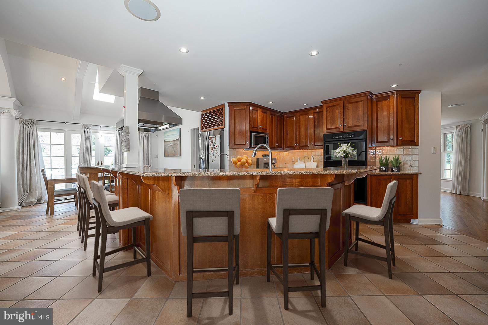 1416 Old Gulph Road Villanova, PA 19085 - Photo 4 of 41 a kitchen with a dining table chairs and white cabinets