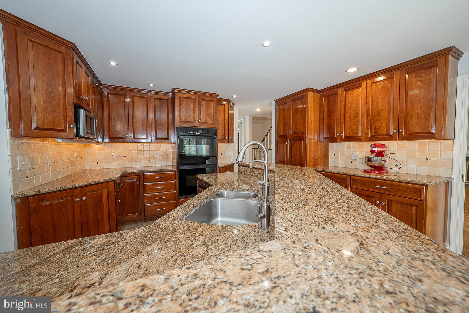 1416 Old Gulph Road Villanova, PA 19085 - Photo 5 of 41 a kitchen with granite countertop a stove sink and cabinets