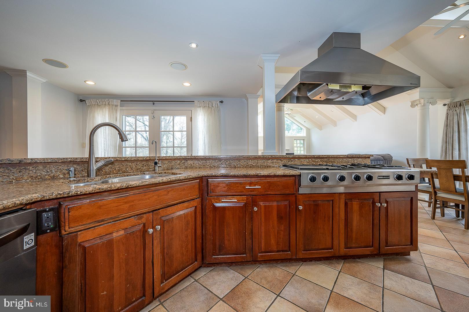 1416 Old Gulph Road Villanova, PA 19085 - Photo 7 of 41 a kitchen with stainless steel appliances granite countertop a stove a sink and a microwave