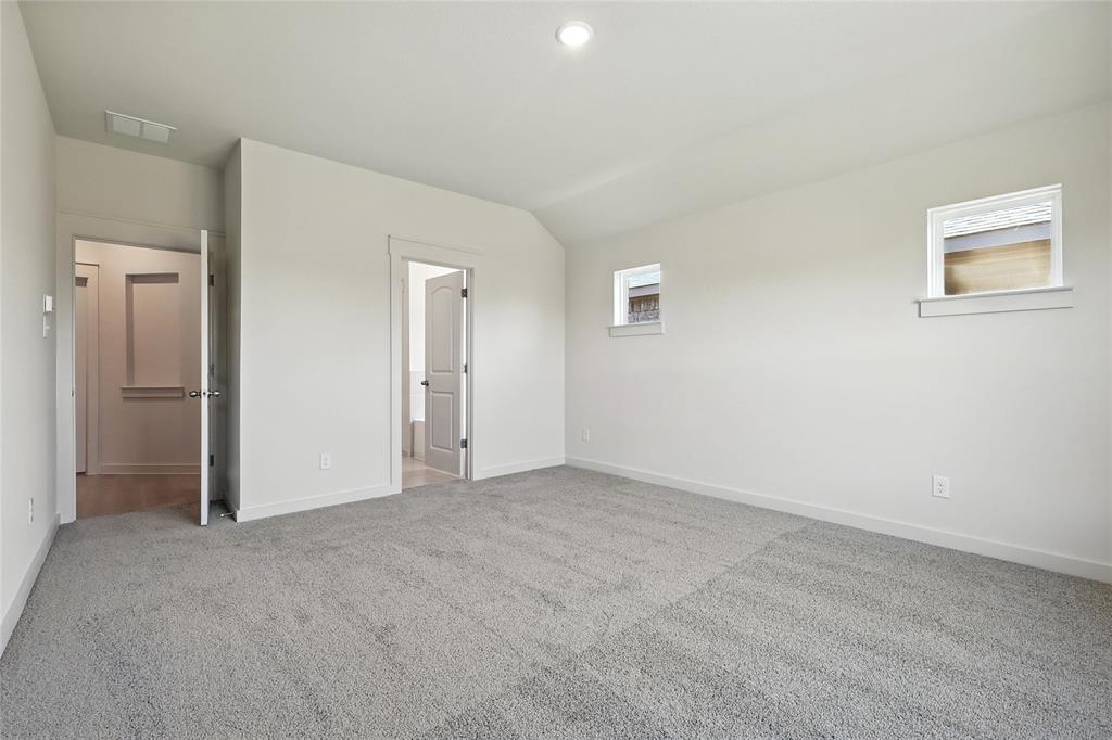 1795 Gleasondale Place Forney, TX 75126 - Photo 14 of 29 Unfurnished bedroom featuring light carpet and lofted ceiling