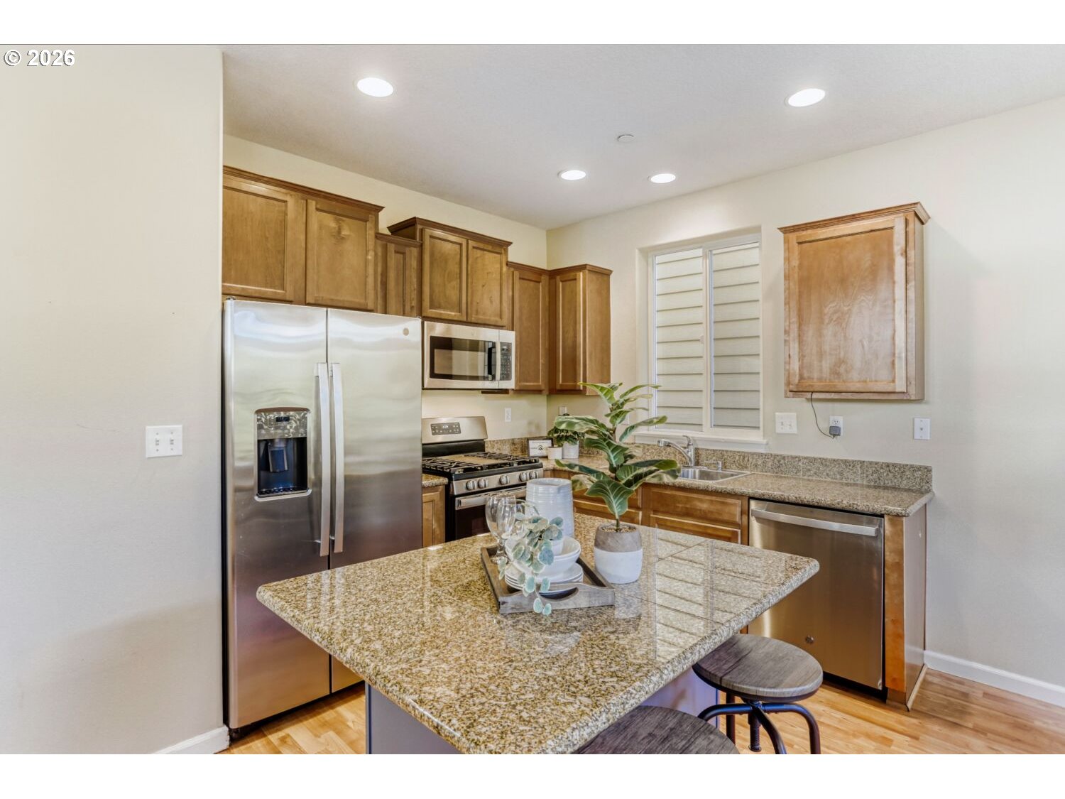 12675 Southwest 158th Terrace Beaverton, OR 97007 - Photo 5 of 26 a kitchen with stainless steel appliances granite countertop a sink refrigerator and cabinets