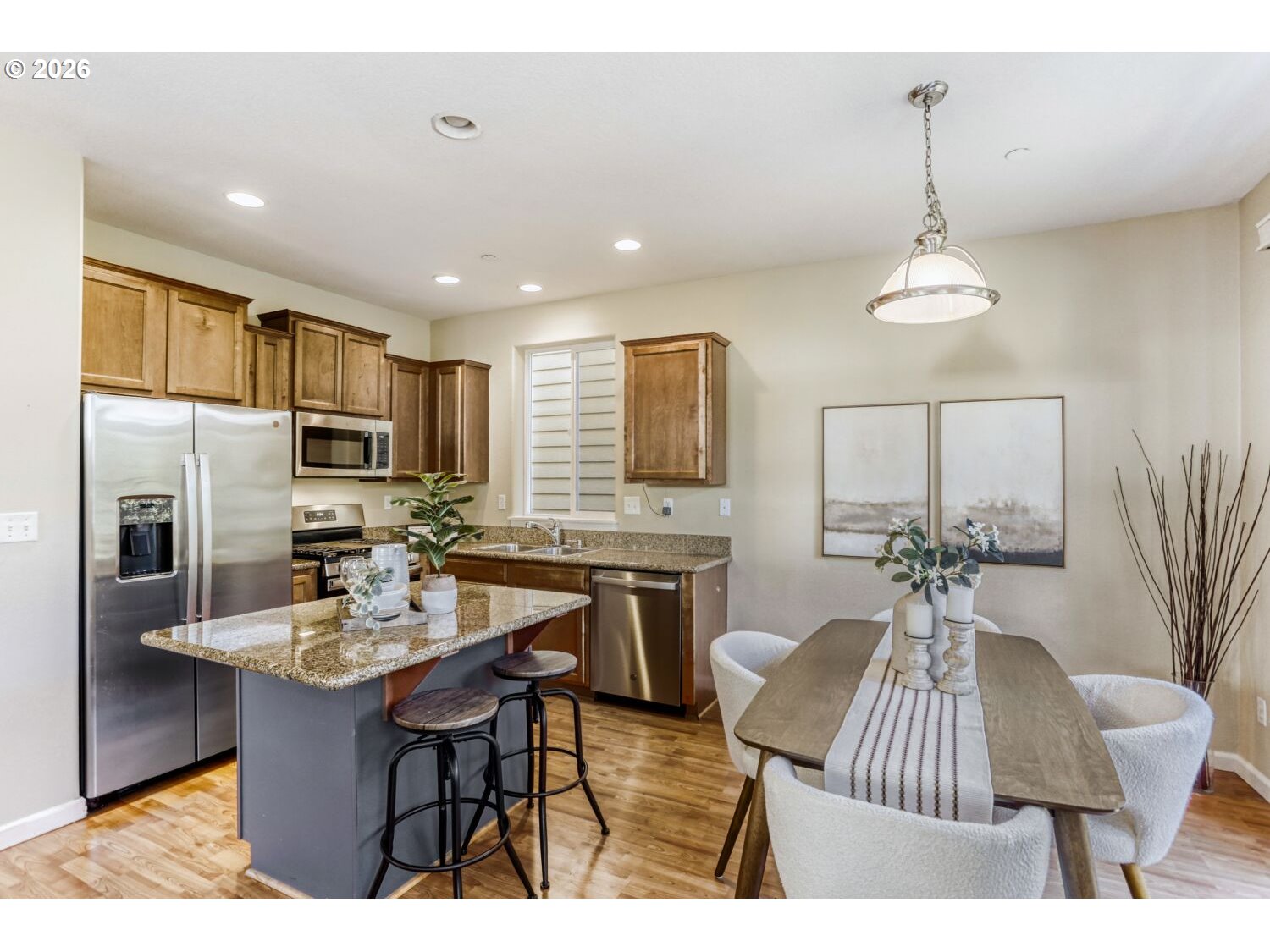 12675 Southwest 158th Terrace Beaverton, OR 97007 - Photo 10 of 26 a kitchen with a table chairs stove and refrigerator