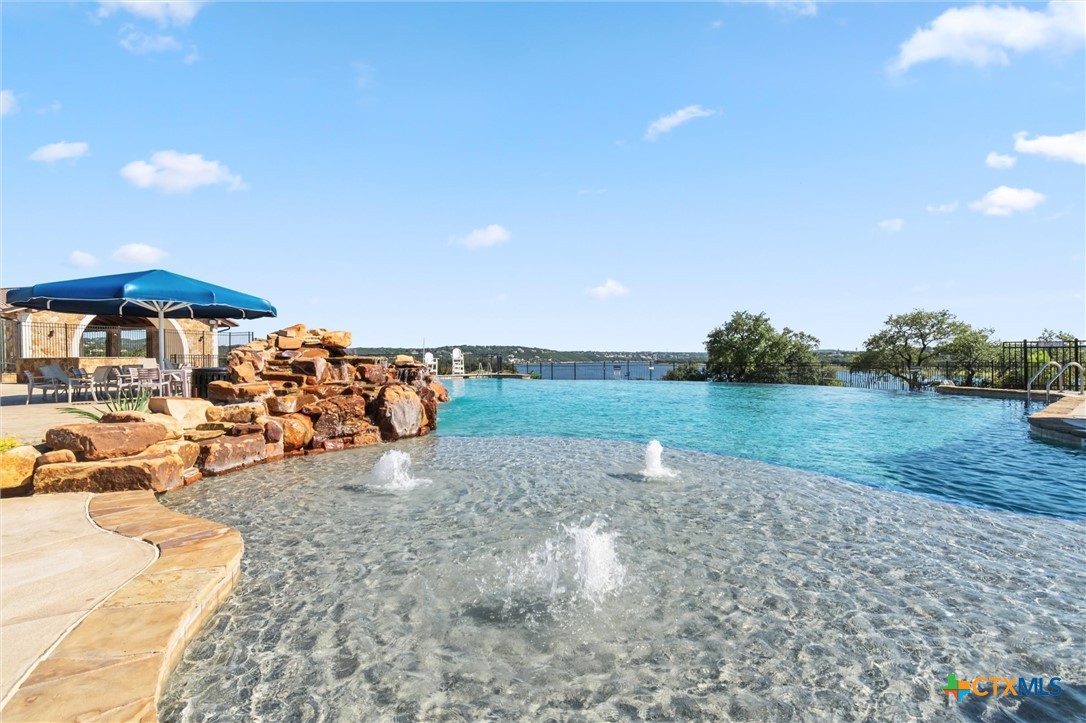 8424 Red Bottle Brush Road Lago Vista, TX 78645 - Photo 2 of 47 community infinity pool
