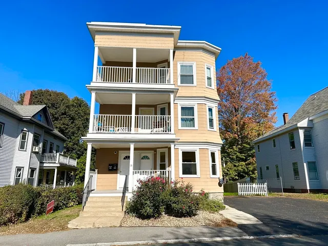 a front view of a building with a yard