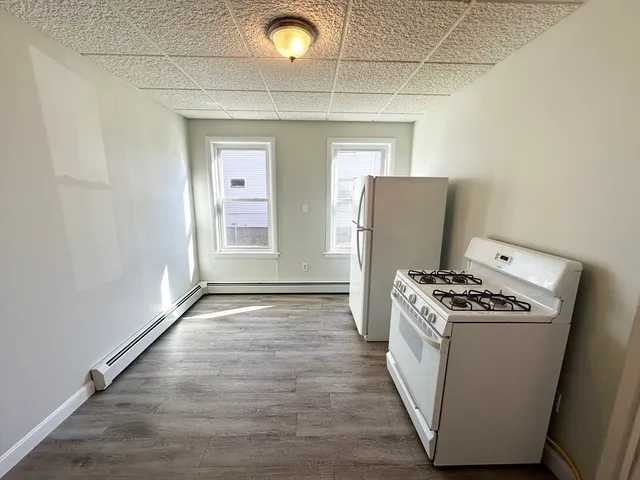a kitchen with granite countertop a stove and a refrigerator