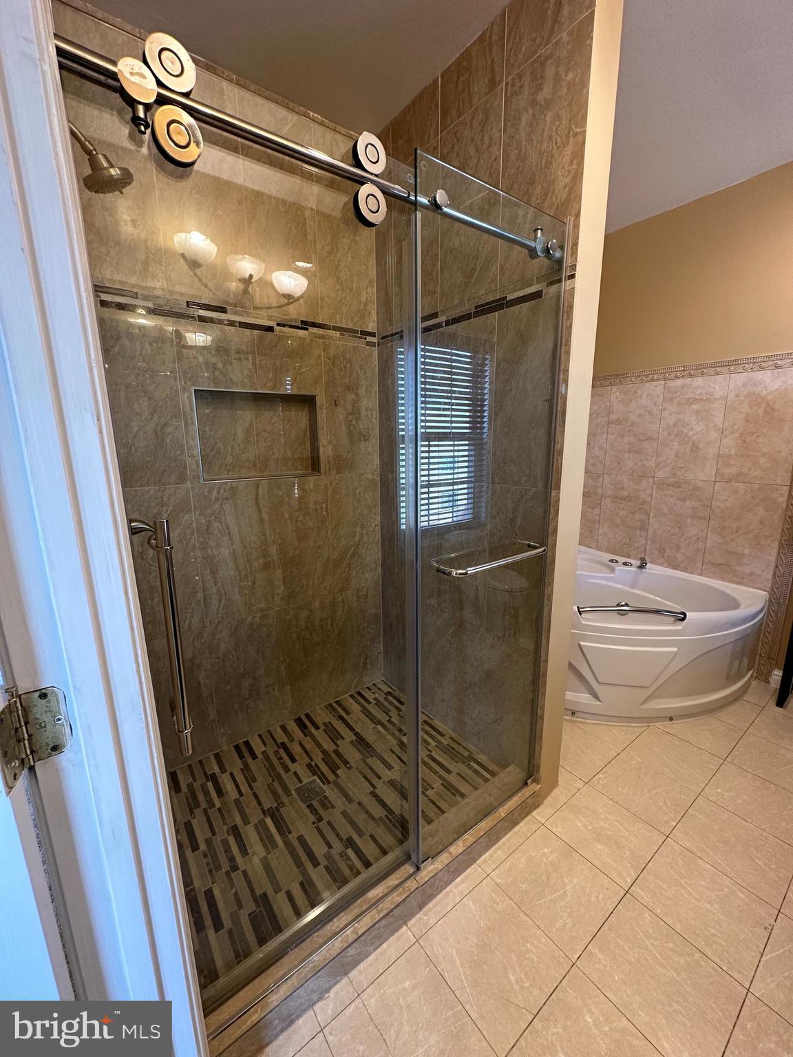 5045 C Street Southeast, Unit 302 Washington, DC 20019 - Photo 19 of 25 Shower in main bedroom bathroom with jacuzzi tub.