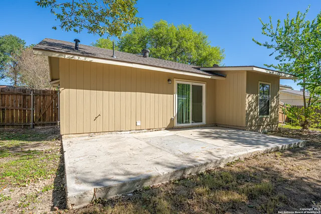 a view of a backyard with a tree