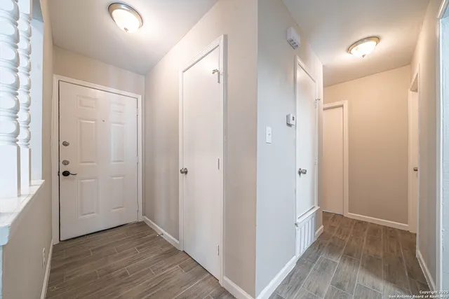 a view of hallway with wooden floor