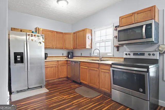 a kitchen with a sink stove and refrigerator
