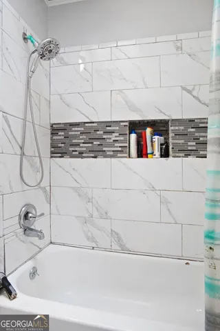 a bathroom with a bathtub and a shower