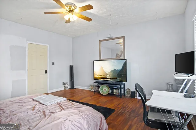 a bedroom with a bed and a flat screen tv