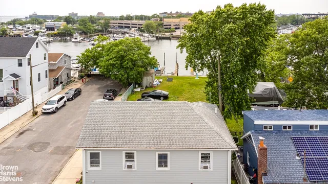 an aerial view of a house with outdoor space and lake view