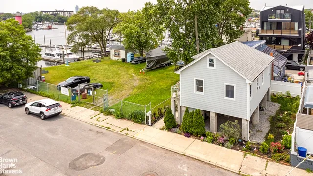 a view of a white house with a yard and sitting area