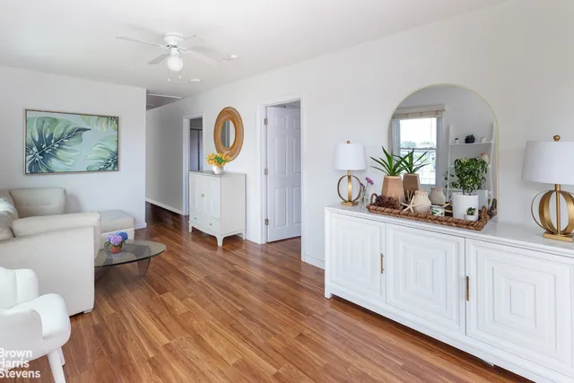 a living room with furniture and wooden floor