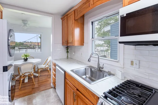 a kitchen that has a sink and a stove